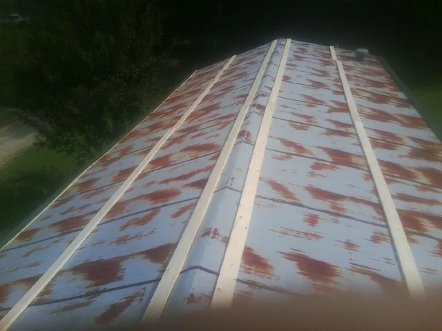 Rusted metal roof panels with new wood purlins before replacement — Storm Damage Roof Repair in Unadilla by Roofing Brothers